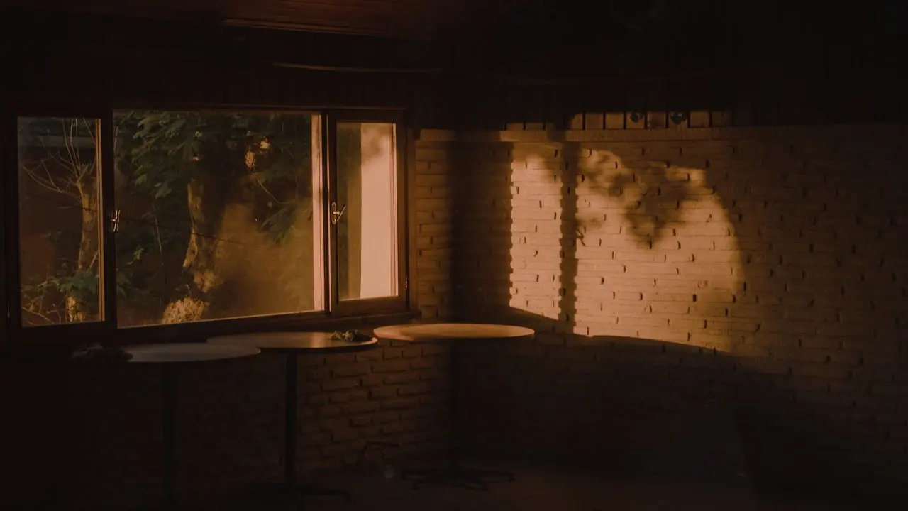 An empty, dimly lit room interior — whether a fire-affected home is safe to sleep in is rarely obvious from looking at it