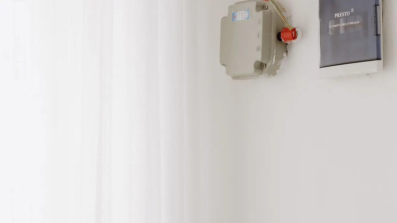 Circuit breaker panel on a wall — cutting power is the first step when a burning smell is sharp and electrical