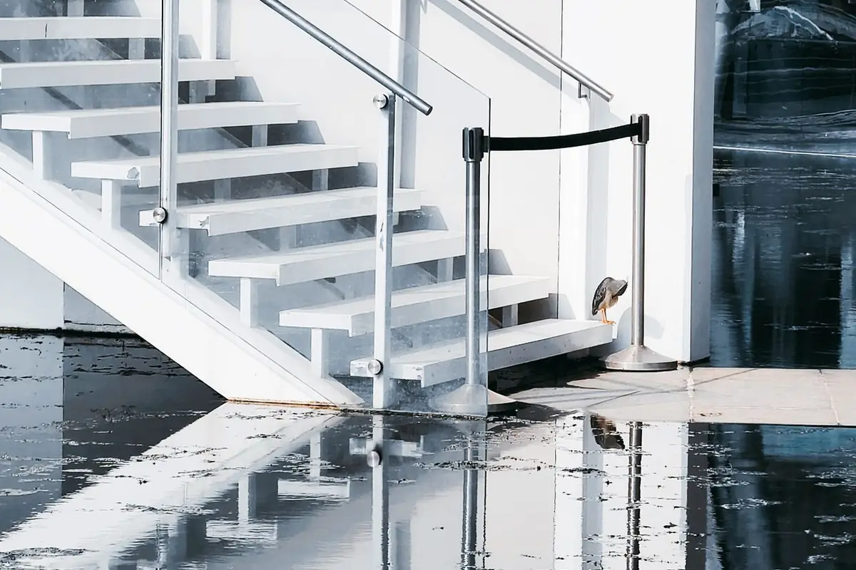 Standing water pooled across an interior floor — suppression water soaks materials the fire never touched
