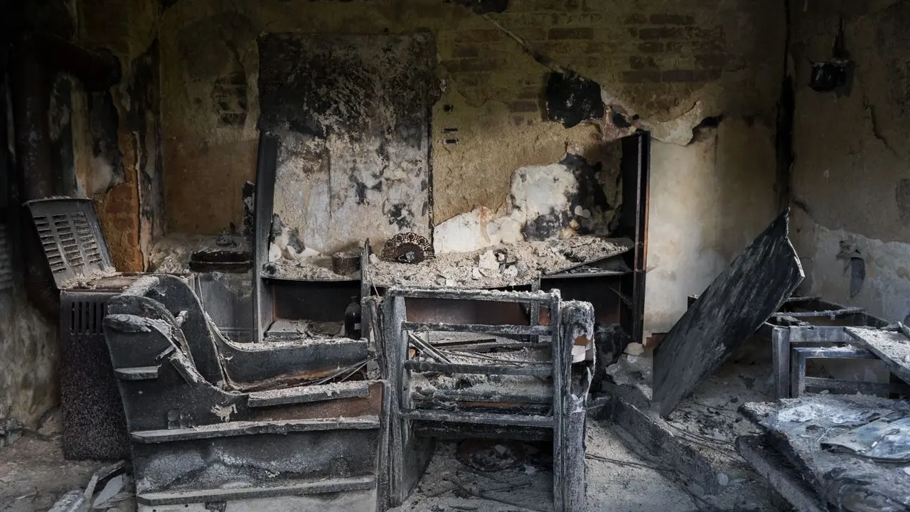 Fire-damaged home interior after the fire service has left — the first day sets up everything that follows